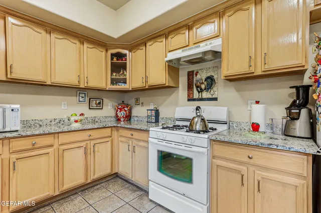 a kitchen with cabinets appliances a sink and a counter top space