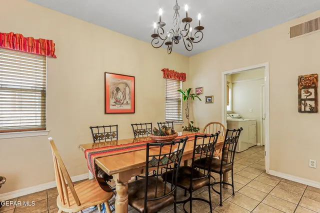 a dining room with furniture and chandelier