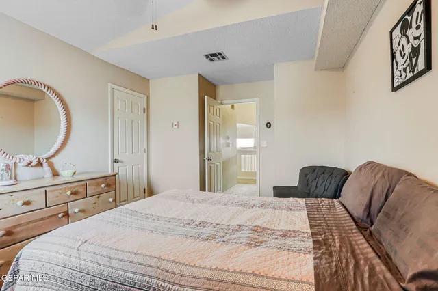 a bedroom with a bed and a dresser