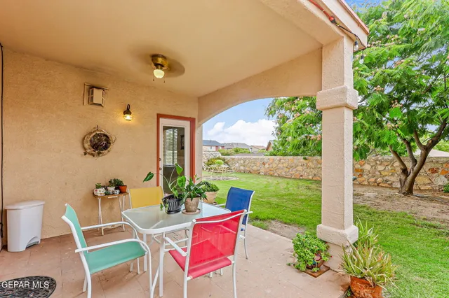 a patio with yard table and chairs