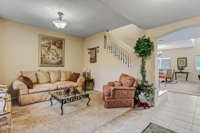 a living room with furniture and a potted plant