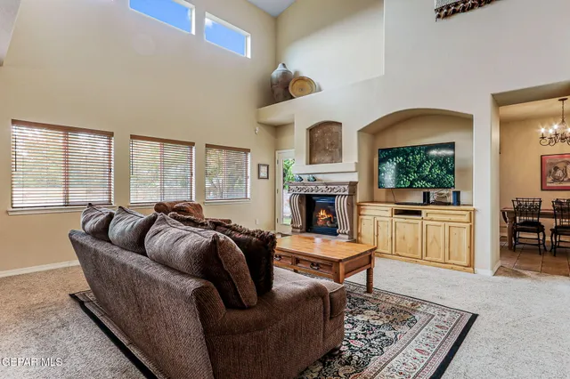 a living room with furniture a fireplace and a table