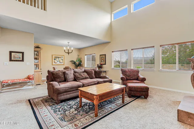 a living room with furniture rug and a large window