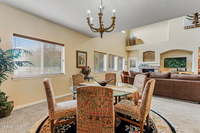 a living room with fireplace furniture and a large window