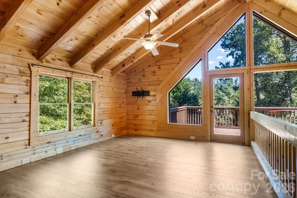 a view of a porch with wooden floor and roof