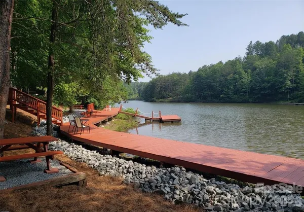a view of a lake with chairs