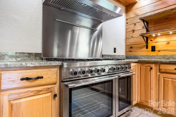 a stove top oven sitting inside of a kitchen