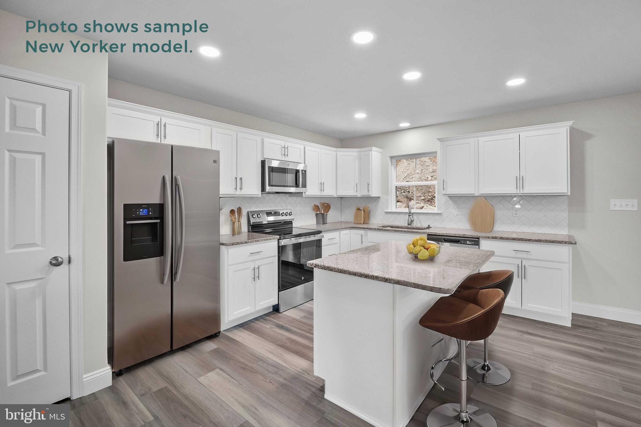 9 Country Club Road Ashland, PA 17921 - Photo 8 of 34 a kitchen with a refrigerator a stove a sink and a dining table with wooden floor