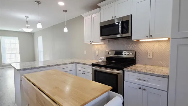 a kitchen with a stove and a microwave