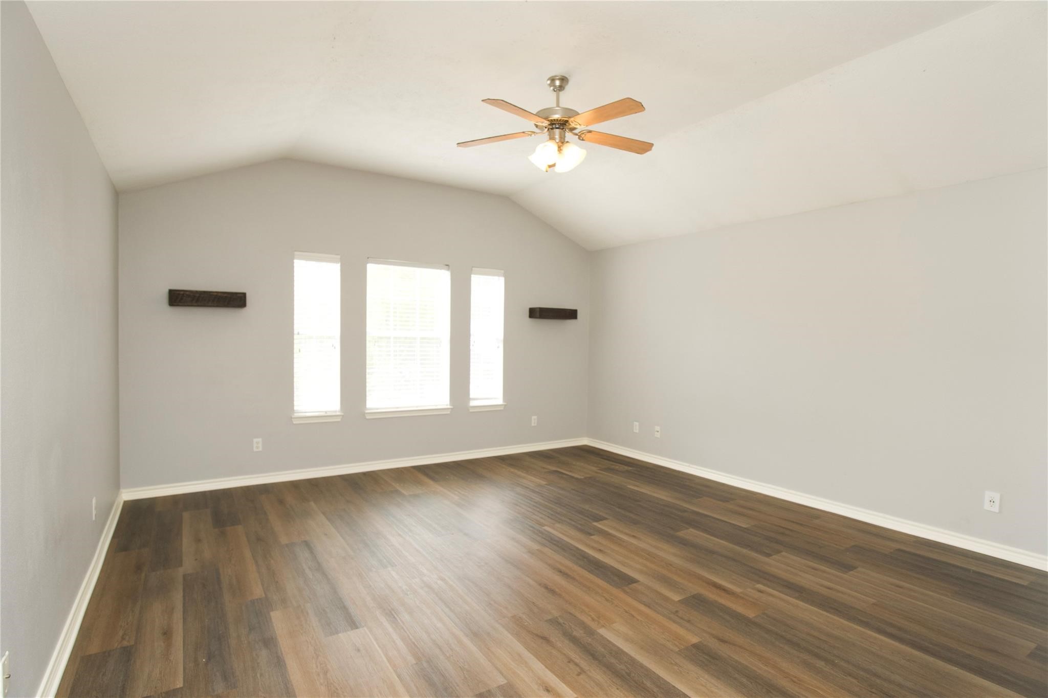 2419 Fox Water Drive Spring, TX 77386 - Photo 11 of 19 an empty room with wooden floor fan and windows