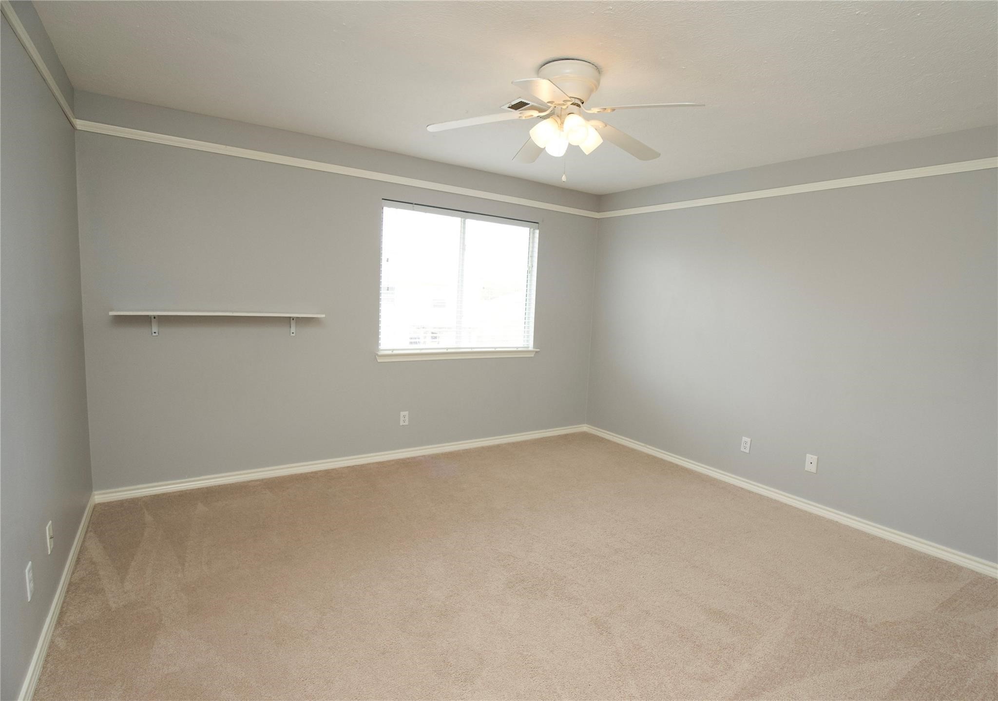 2419 Fox Water Drive Spring, TX 77386 - Photo 13 of 19 an empty room with a chandelier fan and windows