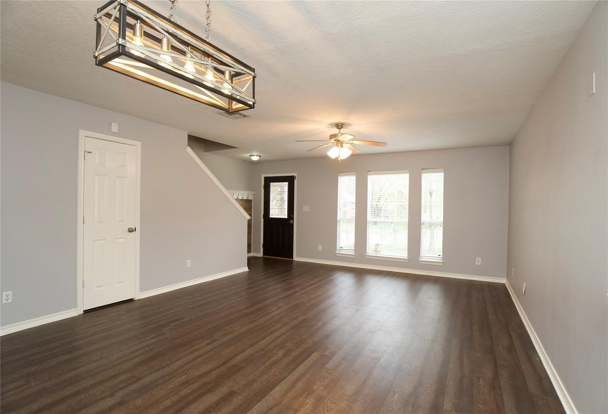 2419 Fox Water Drive Spring, TX 77386 - Photo 3 of 19 a view of an empty room with wooden floor and a window