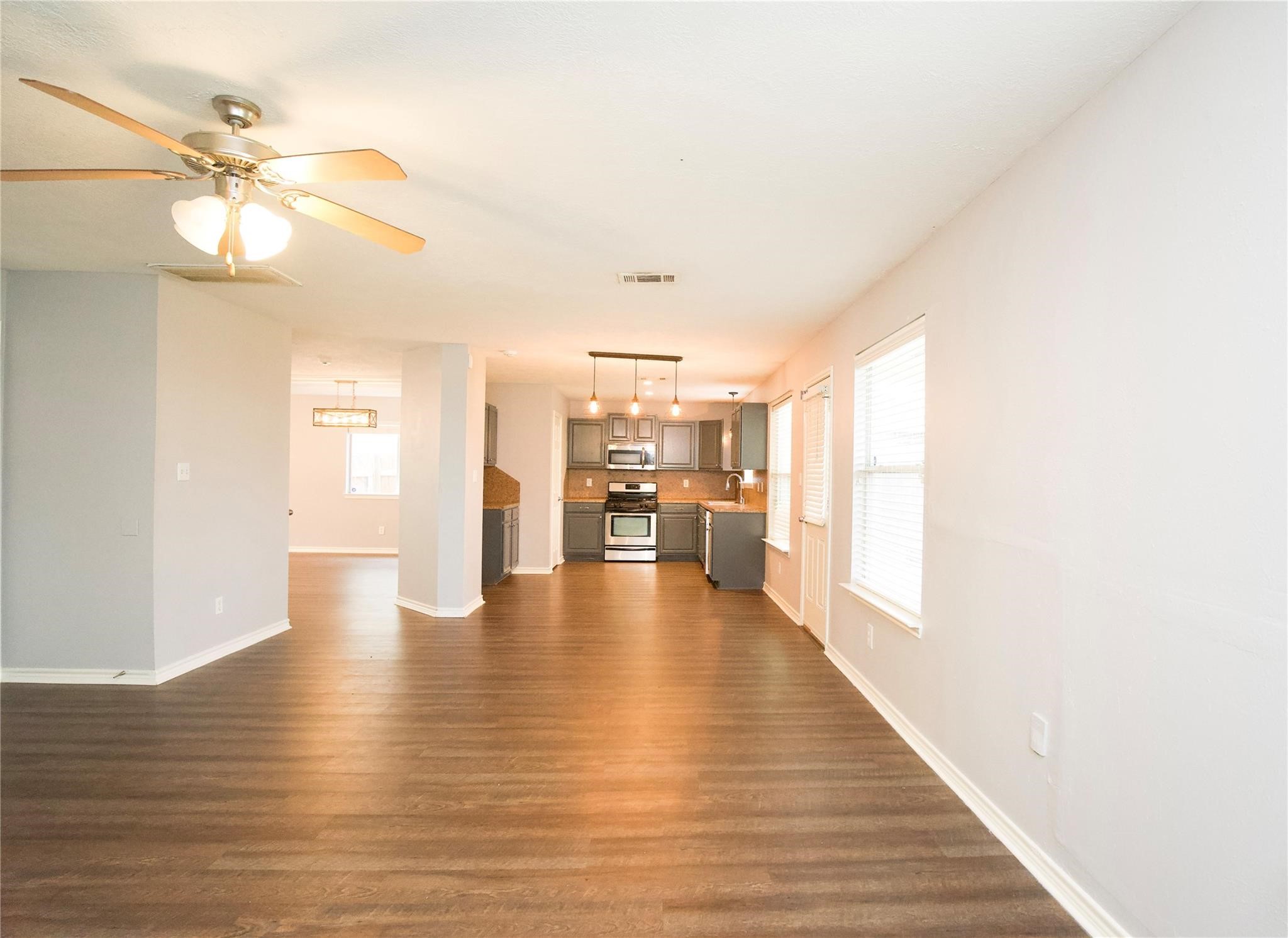 2419 Fox Water Drive Spring, TX 77386 - Photo 7 of 19 a view of a livingroom with furniture wooden floor and a ceiling fan