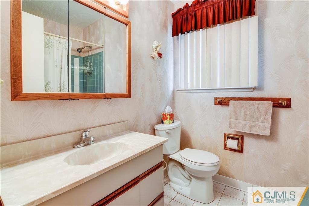 7 Arden Road Old Bridge, NJ 08857 - Photo 15 of 18 a bathroom with a sink a toilet and a mirror