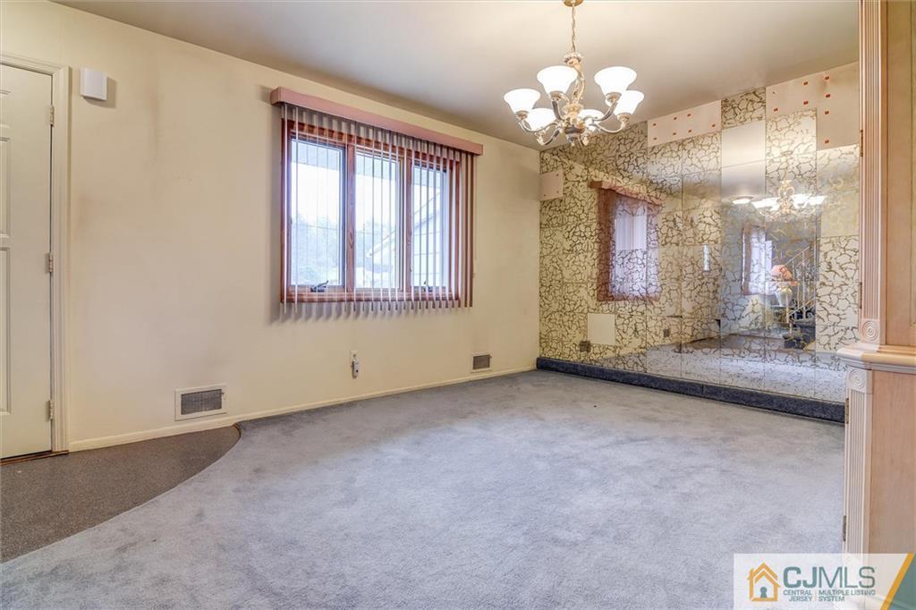 7 Arden Road Old Bridge, NJ 08857 - Photo 3 of 18 a view of a big room with chandelier fan and windows