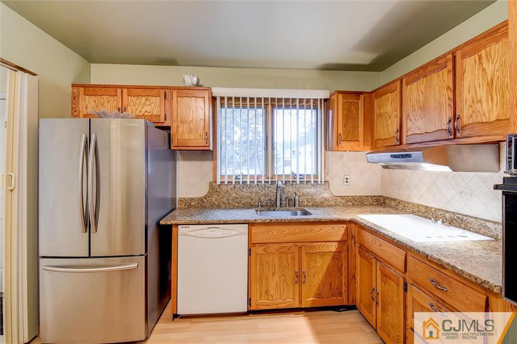 7 Arden Road Old Bridge, NJ 08857 - Photo 6 of 18 a kitchen with granite countertop stainless steel appliances a sink and a refrigerator