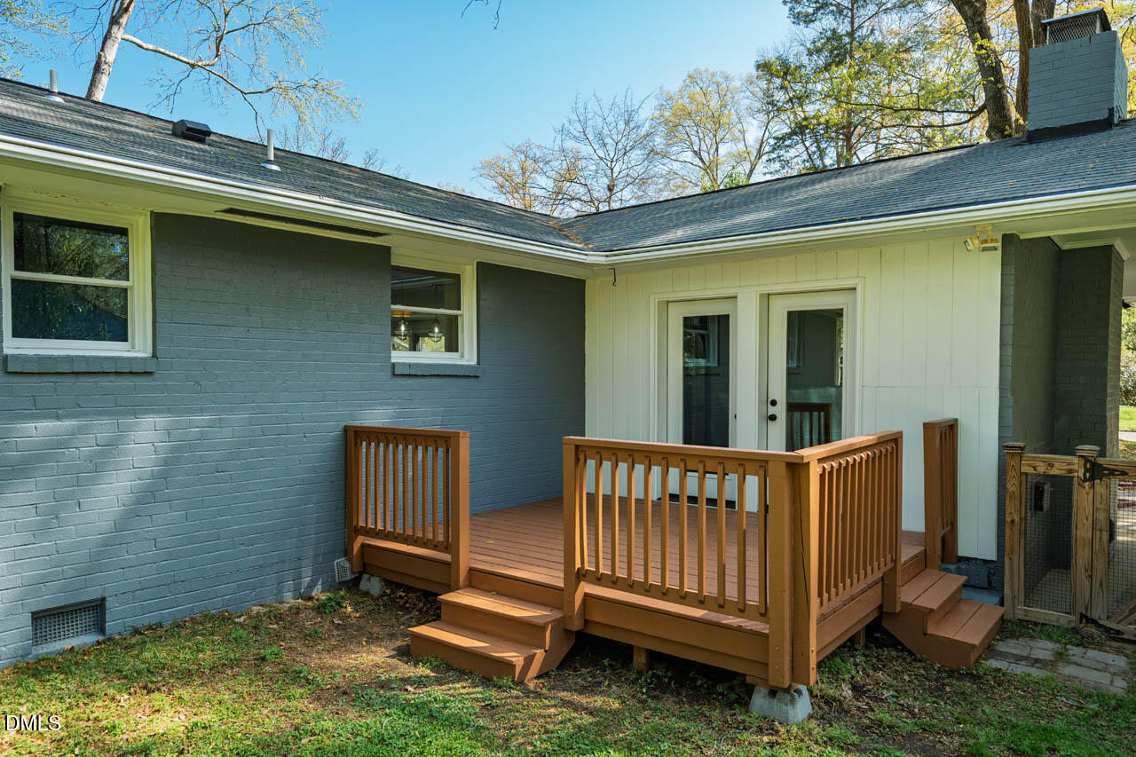 231 Flemington Road Chapel Hill, NC 27517 - Photo 31 of 48 a view of a house with a wooden deck and a small yard