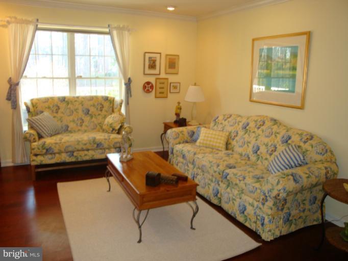 12021 Tralee Road, Unit 201 Lutherville-Timonium, MD 21093 - Photo 14 of 30 a living room with furniture and a window