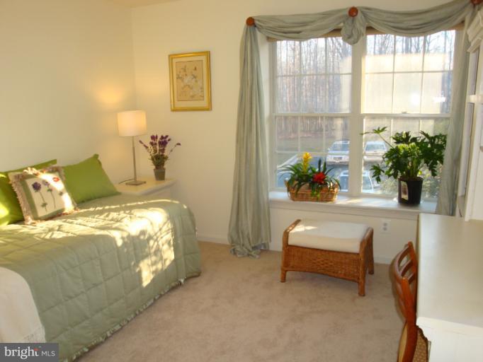 12021 Tralee Road, Unit 201 Lutherville-Timonium, MD 21093 - Photo 23 of 30 a bedroom with bed and a window