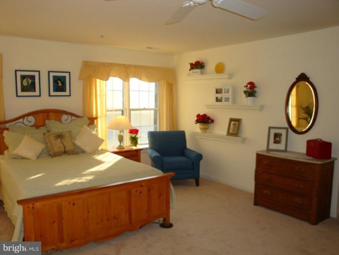 12021 Tralee Road, Unit 201 Lutherville-Timonium, MD 21093 - Photo 24 of 30 a bedroom with a bed and a dresser in it