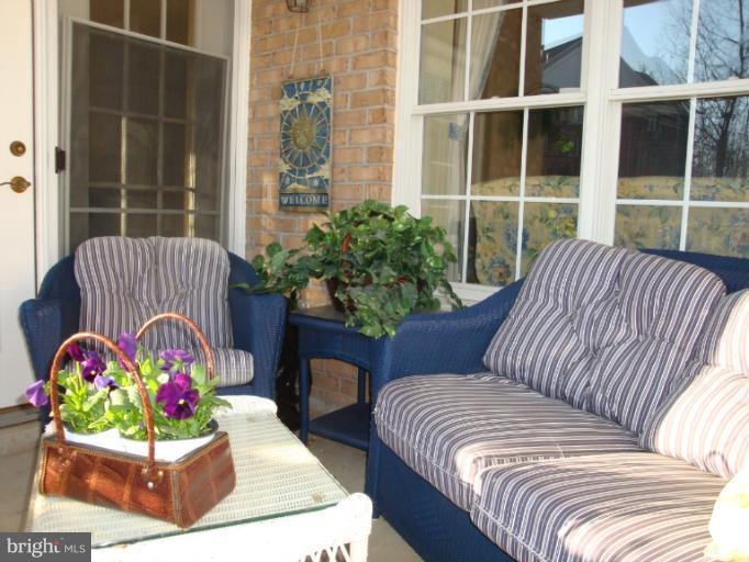 12021 Tralee Road, Unit 201 Lutherville-Timonium, MD 21093 - Photo 27 of 30 a view of a two chairs in the back yard of the house