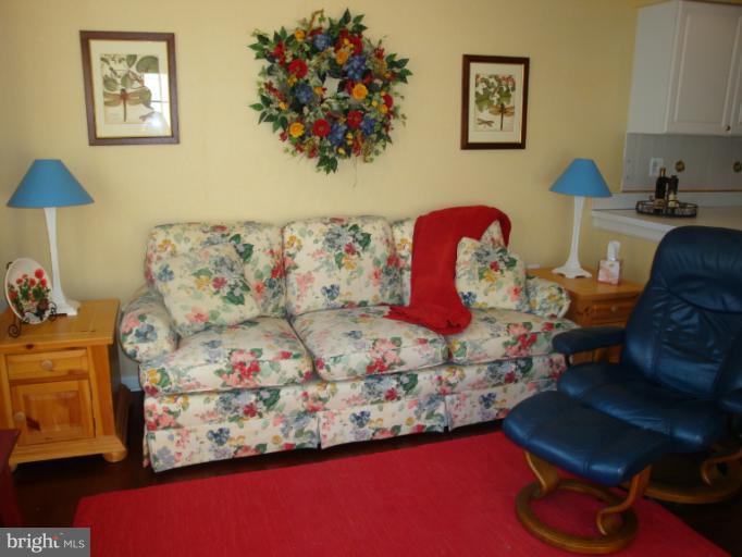 12021 Tralee Road, Unit 201 Lutherville-Timonium, MD 21093 - Photo 4 of 30 a living room with furniture with wooden floor