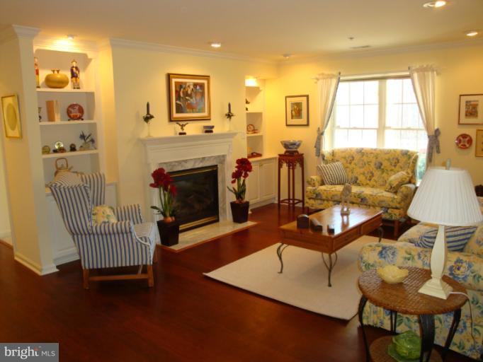 12021 Tralee Road, Unit 201 Lutherville-Timonium, MD 21093 - Photo 6 of 30 a living room with furniture and a fireplace