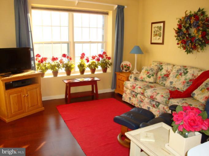 12021 Tralee Road, Unit 201 Lutherville-Timonium, MD 21093 - Photo 7 of 30 a living room with furniture and a flat screen tv