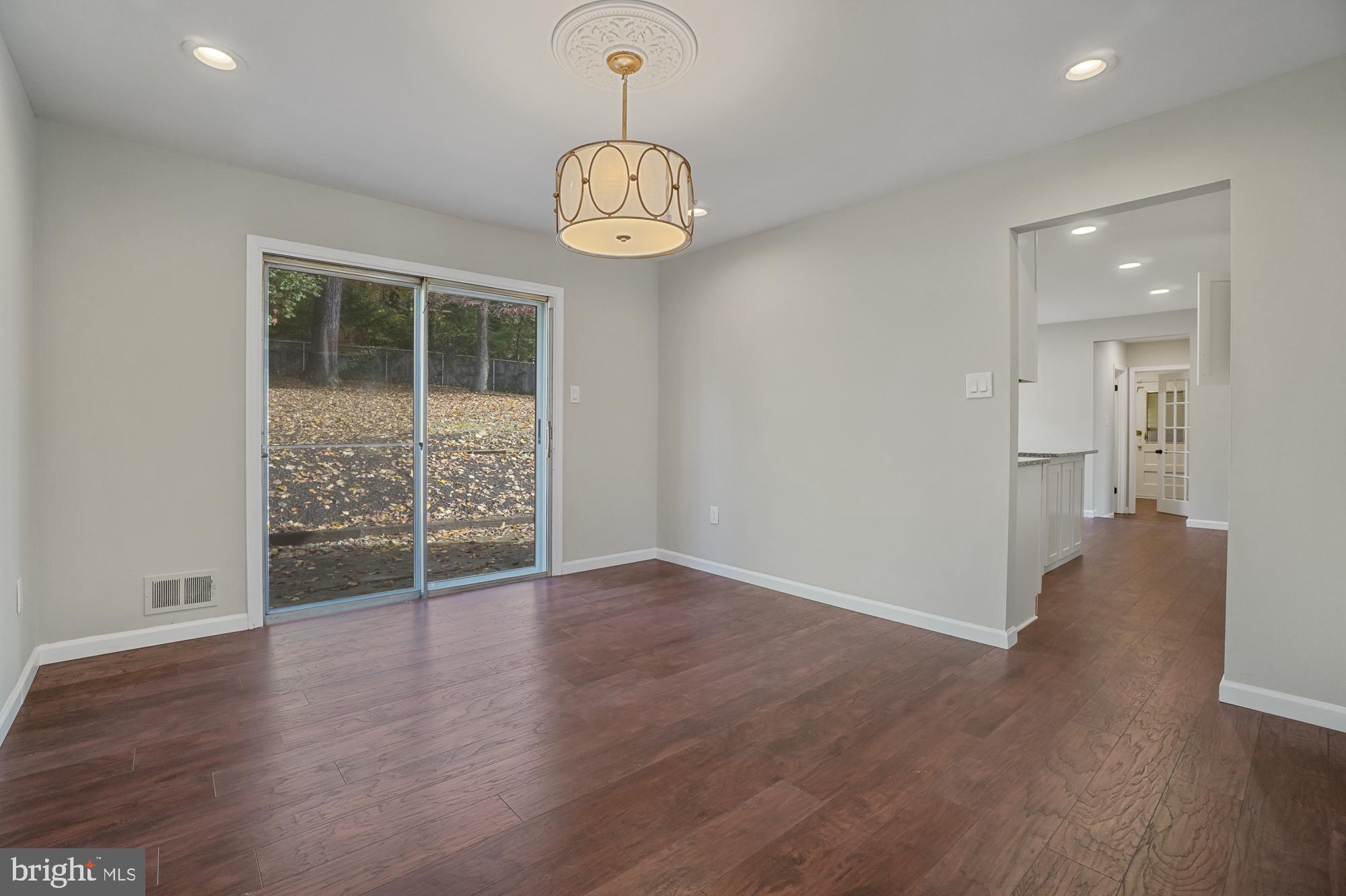 12539 Heurich Road Silver Spring, MD 20902 - Photo 6 of 46 an empty room with wooden floor and windows