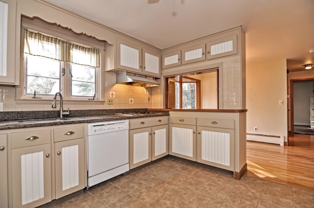 66 Old Post Road Walpole, MA 02032 - Photo 17 of 30 a kitchen with white cabinets and a window