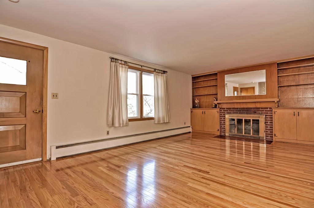 66 Old Post Road Walpole, MA 02032 - Photo 9 of 30 an empty room with wooden floor fireplace and windows