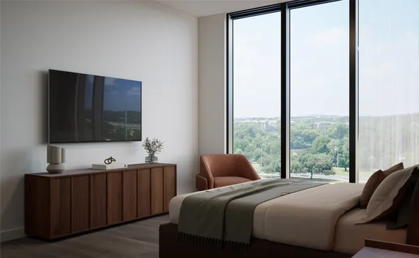 a bedroom with a bed and large window