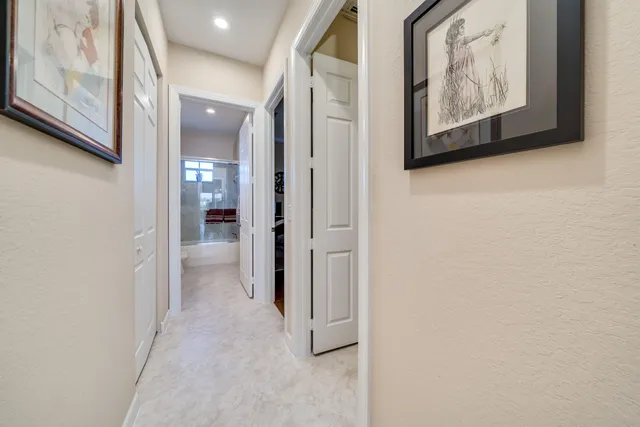 a view of a hallway with paintings on the wall