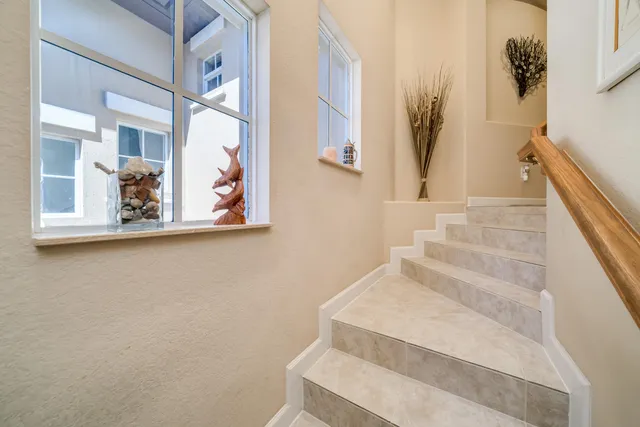 a view of staircase with white walls and a window