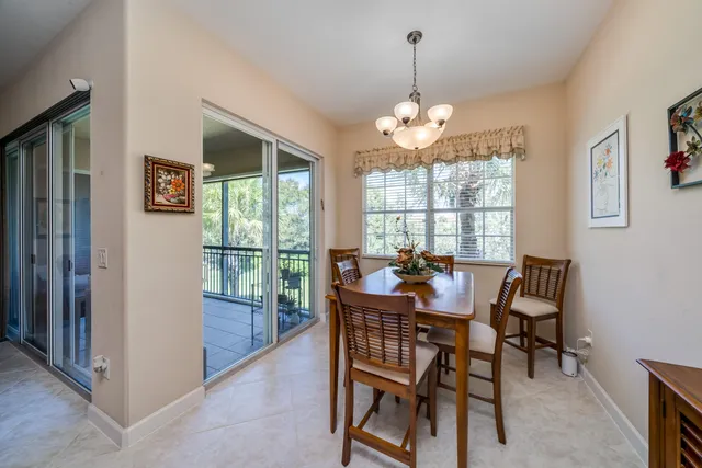 a dining room with furniture a chandelier and window