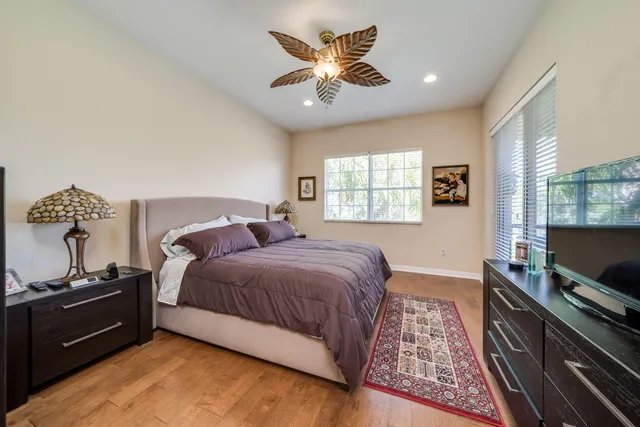 a bedroom with a bed and wooden floor