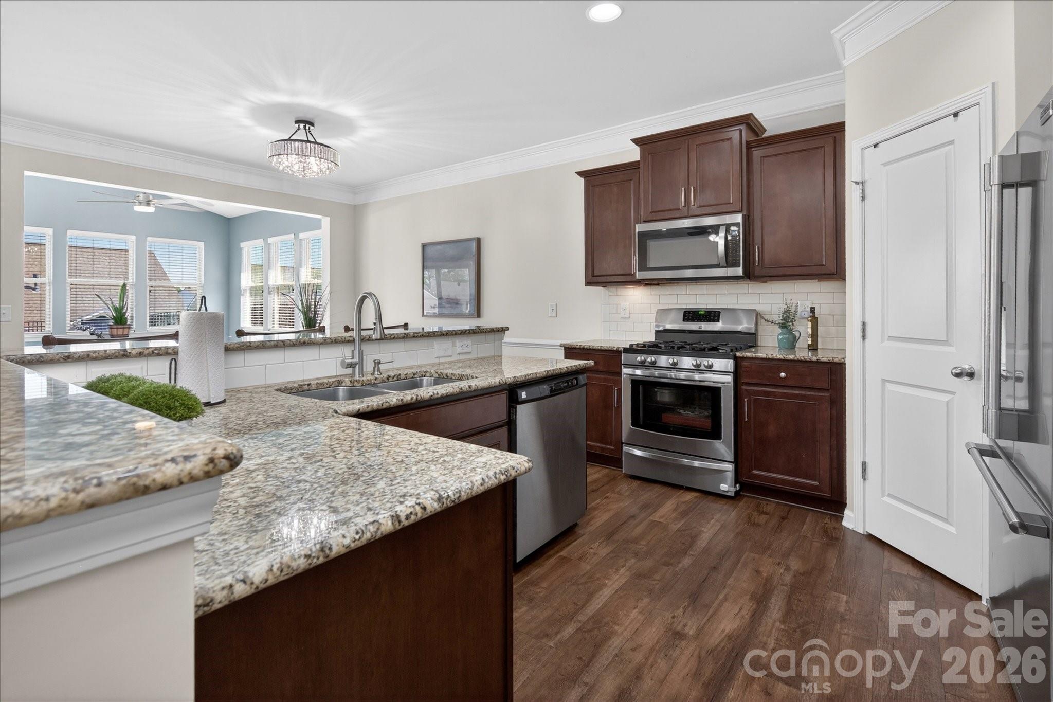 2032 Pinyon Lane Lancaster, SC 29720 - Photo 14 of 44 a kitchen with stainless steel appliances granite countertop a sink stove and refrigerator