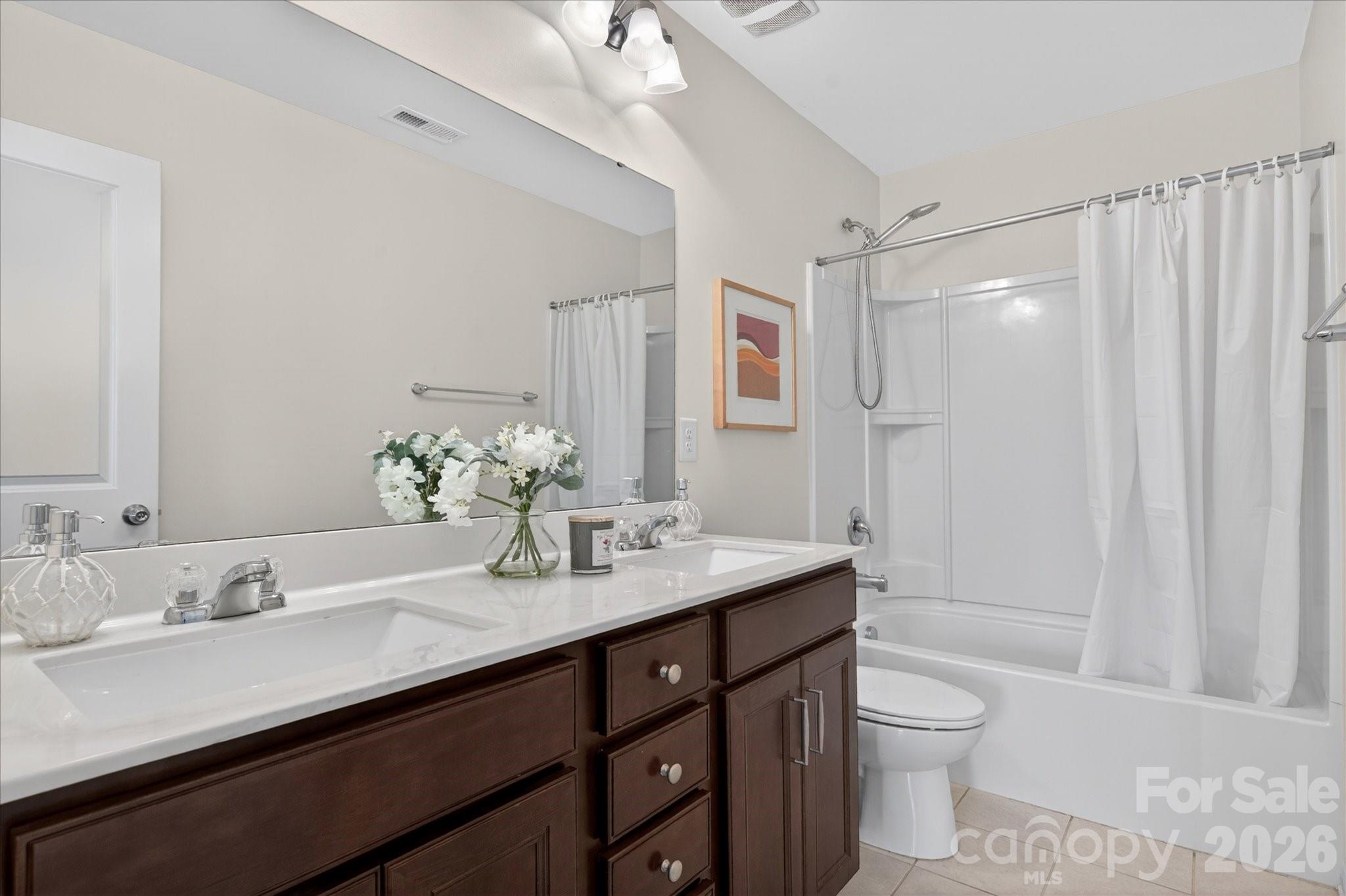 2032 Pinyon Lane Lancaster, SC 29720 - Photo 33 of 44 a bathroom with a granite countertop sink a toilet and shower