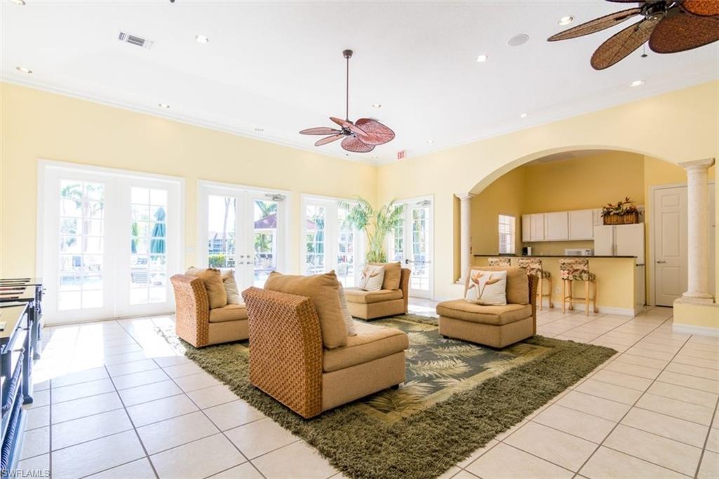 4635 St Croix Lane, Unit 1218 Naples, FL 34109 - Photo 29 of 40 Living room with ceiling fan, light tile patterned flooring, arched walkways, french doors, and decorative columns