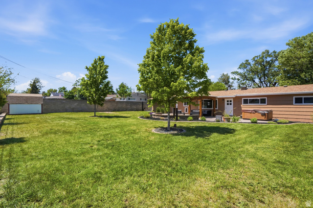 6889 South Village Road Salt Lake City, UT 84121 - Photo 34 of 44 Expansive green lawn with mature trees and perimeter block wall