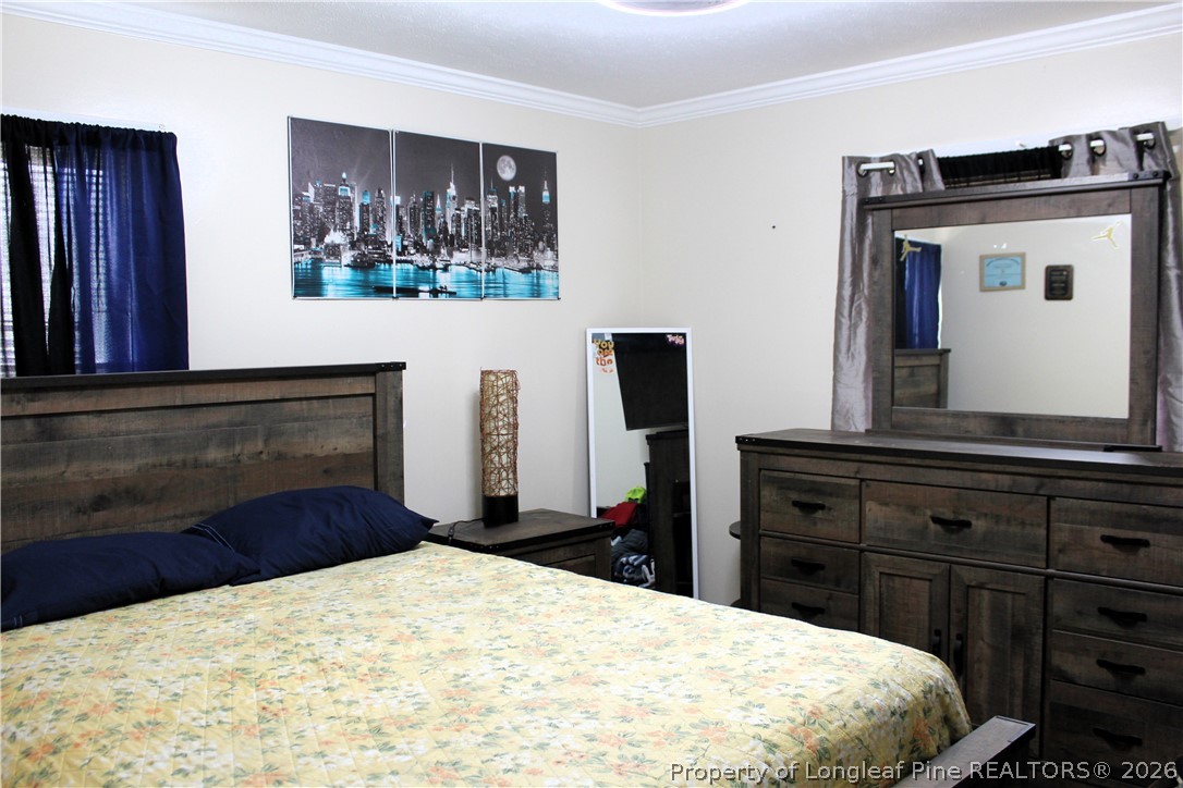 2038 Dunn Road Eastover, NC 28312 - Photo 18 of 29 a bedroom with a bed and a dresser