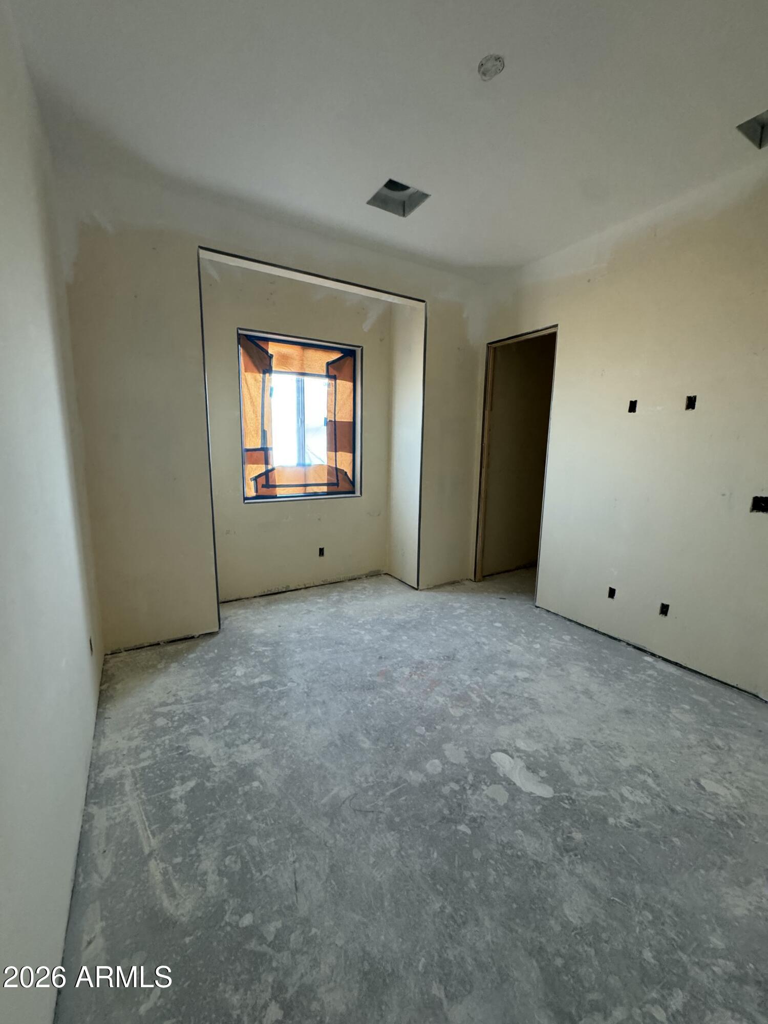 15728 West Montgomery Road Surprise, AZ 85387 - Photo 15 of 19 an empty room with windows