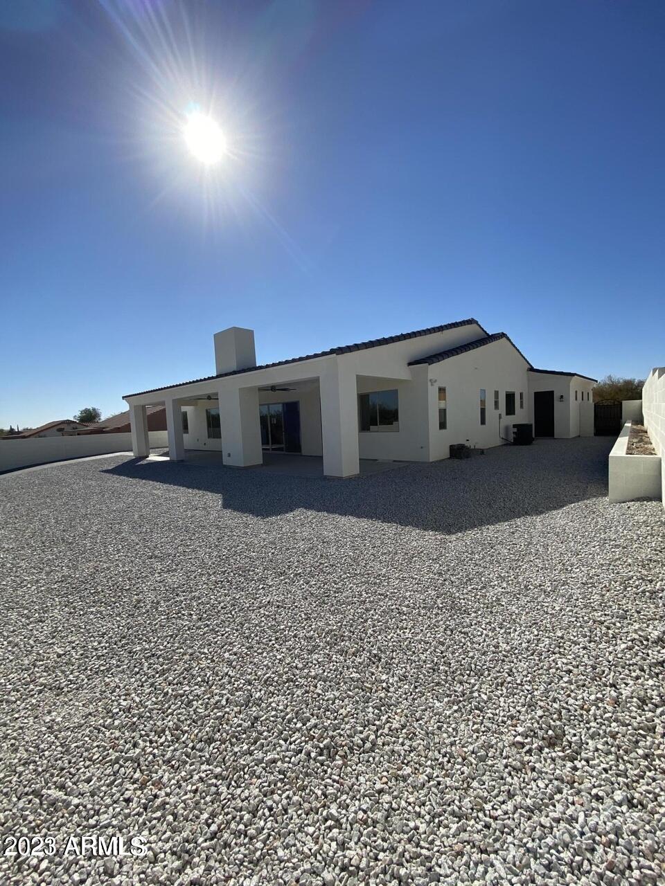 15728 West Montgomery Road Surprise, AZ 85387 - Photo 5 of 19 a large building with a large parking space and a car parked in front of it