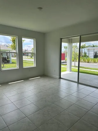 a view of an empty room with a fireplace and a window