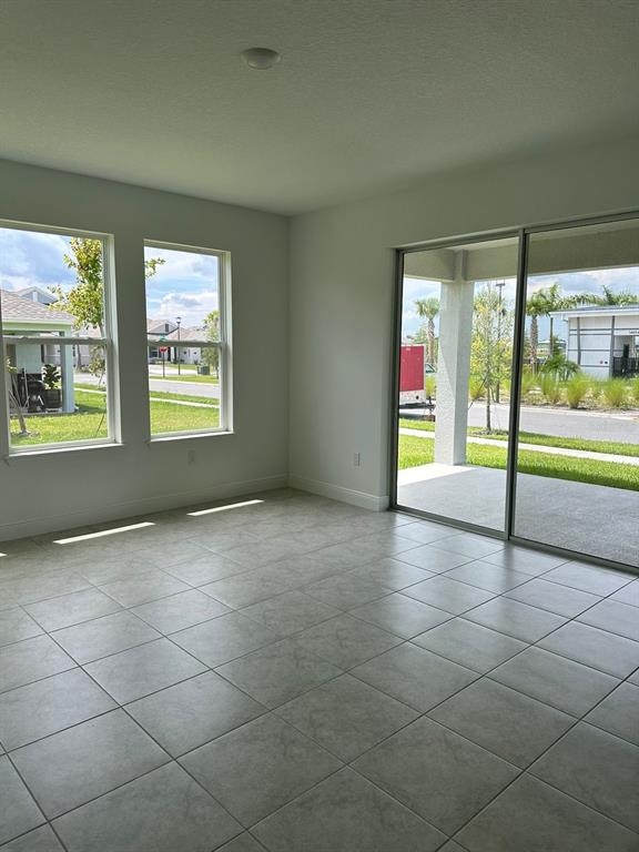 19044 Blueleaf Street Orlando, FL 32827 - Photo 12 of 42 a view of an empty room with a fireplace and a window