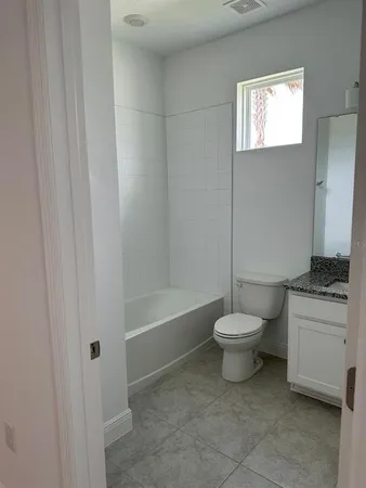 a bathroom with a toilet a sink and a bathtub