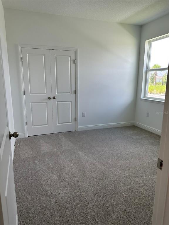 19044 Blueleaf Street Orlando, FL 32827 - Photo 18 of 42 an empty room with windows