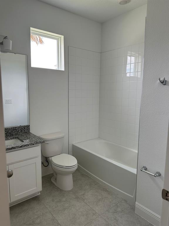 19044 Blueleaf Street Orlando, FL 32827 - Photo 20 of 42 a bathroom with a granite countertop toilet a sink and a bathtub