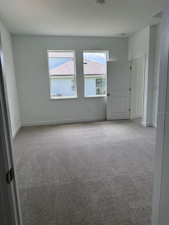 19044 Blueleaf Street Orlando, FL 32827 - Photo 29 of 42 an empty room with windows