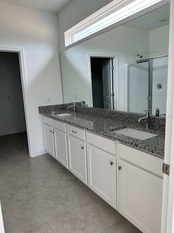 19044 Blueleaf Street Orlando, FL 32827 - Photo 33 of 42 a bathroom with a granite countertop sink and a mirror